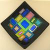 GEOMETRIC EXTROVERT # 103:
Fused and slumped black sushi dish with dichroic onlay.  Measures 7 inches square.  $175