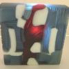 MORNING COMMUTE:
Kiln cast glass sculptural block. Cold-worked with surface carving and edging and sand-blasted. Measures 8Lx8Hx1.75W. Do you see a lady draped in ruby red  standing between the seats of the subway? Contact me for pricing.