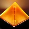 AMBER PYRAMID:
  Cast glass  pyramid.  Base is 5 3/4 inches square with pyramid 4.25 inches in height.  The four surfaces were cold worked and sand blasted.  The base and edges were polished, enabling the viewer to peer into the  mystery of the pyramid.  Base from SW Acrylics.  Contact me for price.