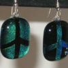 Peace Sign Earrings:
Fused dichroic glass earrings in blue/green. Order as POSITIVE (peace sign is colored) or NEGATIVE ( peace sign is black and background is blue/green). Measures 1Hx.75 W. Sterling silver, hypo-allergenic earring hoops used. $25 each