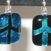 Peace Sign Earrings:
Fused dichroic glass earrings in blue. Order as POSITIVE  (peace sign is blue) or NEGATIVE (peace sign is black with blue background).  Measures 1Hx.75W. Sterling silver, hypo-allergenic earring  hoops used. $25 each