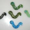 Earthworms:
Cast glass earthworms.  Measure 3.5L. Available in a variety of colors. $10 each
