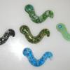 Earthworms:
Cast glass earthworms.  Measure 3.5L. Available in a variety of colors. 